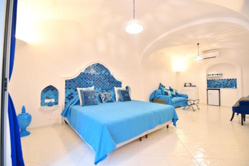 a bedroom with a blue bed in a room at Casa Mulini in Positano