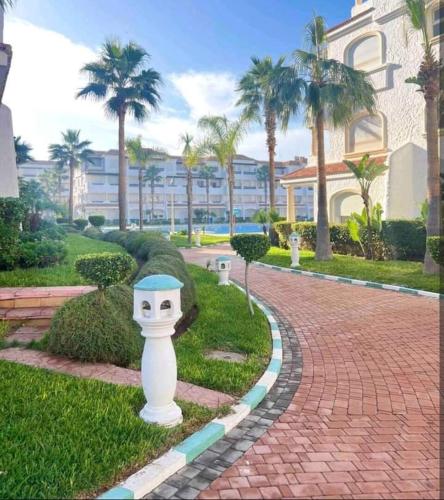 a statue of a face on a brick road at Garden Beach 2 sidi rahal in Sidi Rahal