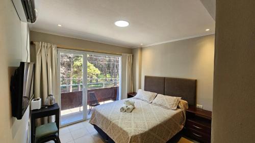 a bedroom with a bed with two teddy bears on it at Hotel Firenze in Necochea