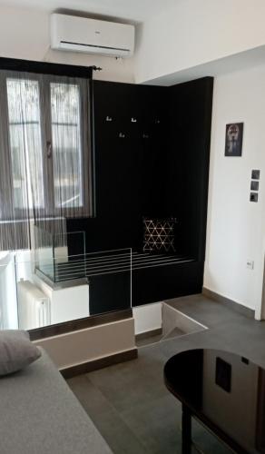 a living room with a black wall and a table at Studio Eleni in Plomarion