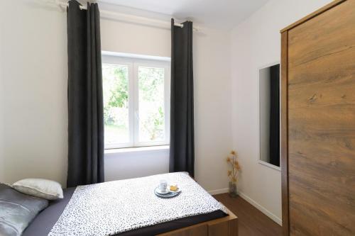 a bedroom with a bed and a window at Villa Sentia with jacuzzi & spectacular seaview in Opatija