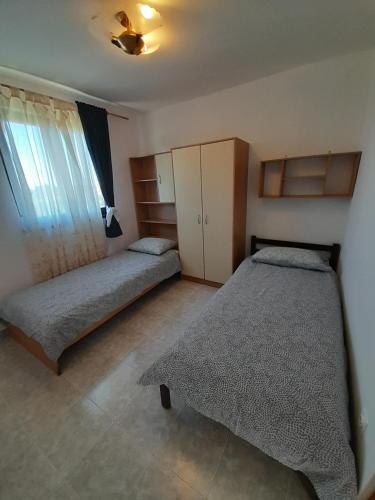 a bedroom with two beds and a window at Apartment Mihael - 4 persons in Vodnjan