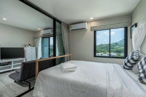 a bedroom with a large bed and a large window at С1O Новые Рубль ватсап669З582I976 in Nai Yang Beach