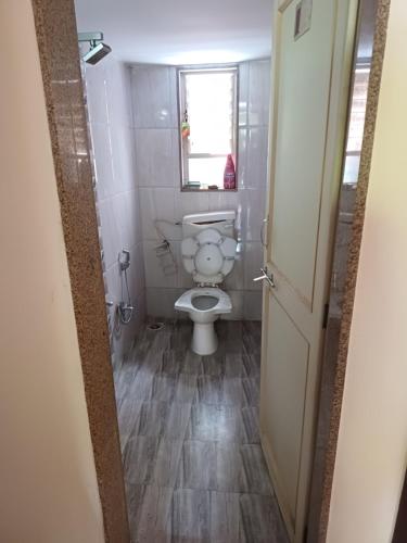 a bathroom with a white toilet in a room at 2 BHK Row house, WFH in Peaceful place, Wakad 20 Km, Hinjewadi Ph II 25km, Lonavala 29km, Kamshet 12km, Chakan 25 km in Pune