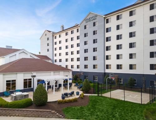 an exterior view of a hotel with a courtyard at Homewood Suites by Hilton Chester in Chester