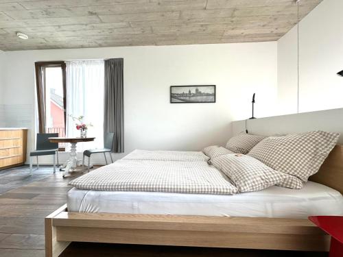 a bedroom with a large bed and a table at Cologne Country Lodge in Cologne