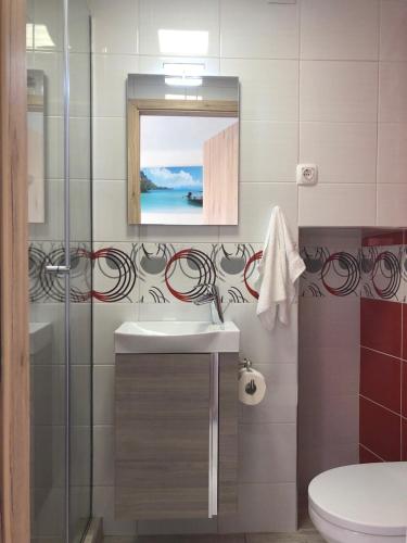 a bathroom with a sink and a mirror at Romantic Villa Centar Omisalj in Omišalj