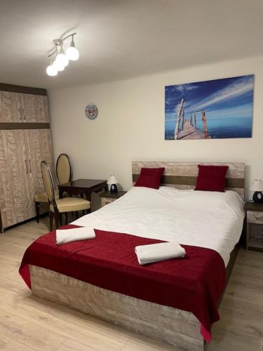 a bedroom with a large bed with red pillows at Romantic Villa Centar Omisalj in Omišalj