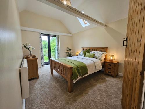 a bedroom with a large bed and a window at Lilys Cottage Mendlesham Green Stowmarket Suffolk in Stowmarket