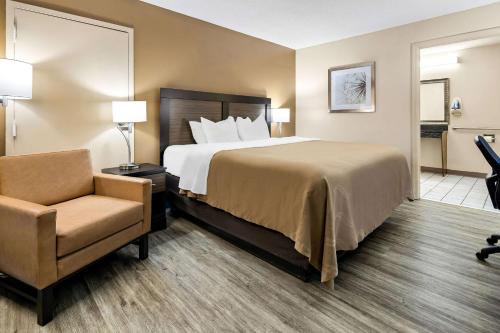 a hotel room with a bed and a chair at Quality Inn Decatur River City in Decatur