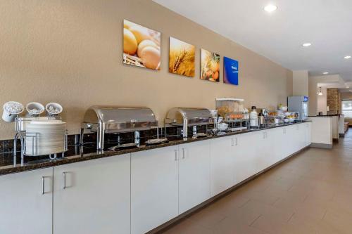 a kitchen with white cabinets and a counter at Comfort Suites Coralville I-80 in Coralville