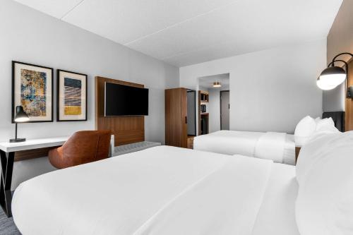 a hotel room with two beds and a tv at Comfort Inn & Suites York North in York