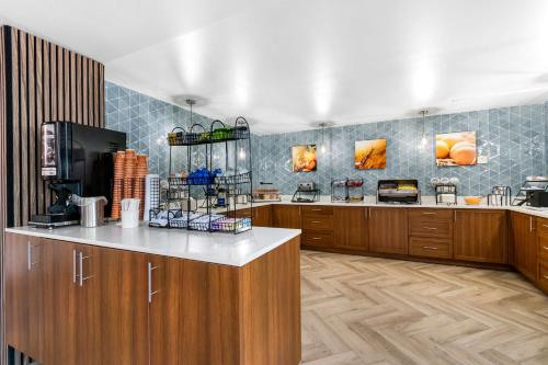 a large kitchen with wooden cabinets and a counter at Comfort Inn & Suites York North in York