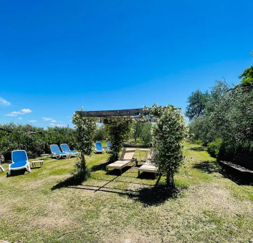 a group of chairs and tables in a yard at Cà Donzella in Lazise