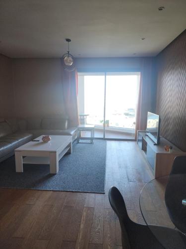 a living room with a couch and a table at Casablanca Marina by Saloua in Casablanca