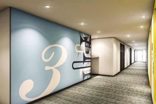 a hallway with a large number on the wall at Comfort Hotel Hamamatsu in Hamamatsu
