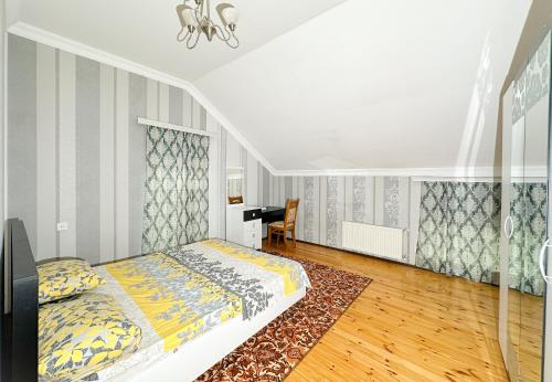 a bedroom with a bed and a desk at Love Garden House in Gabala