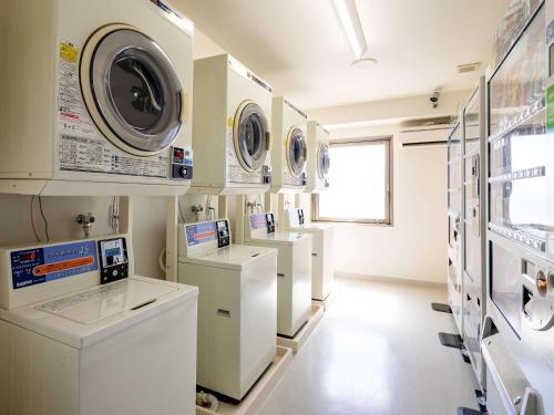 a laundry room with washing machines and washers at Comfort Hotel Hamamatsu in Hamamatsu