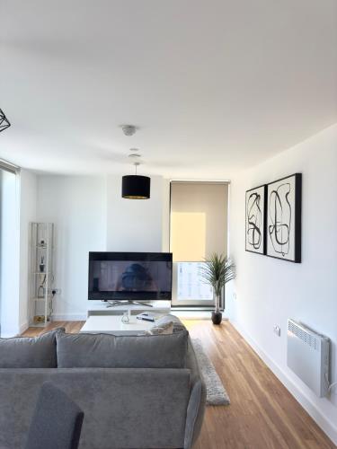 a living room with a couch and a tv at Your private oasis in Manchester in Manchester