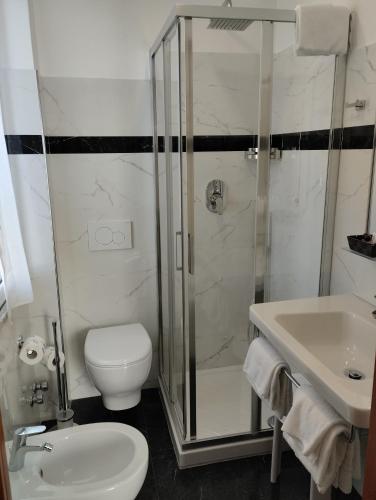 a bathroom with a shower and a toilet and a sink at Hotel Tiffany in Ceriale