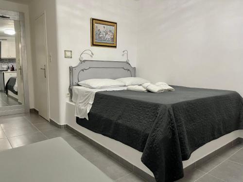 um quarto com uma cama com um cobertor preto em Mykonos Secret Spot em Míconos