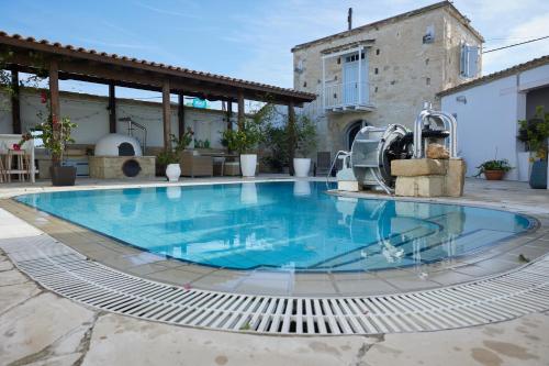 a large swimming pool in the middle of a courtyard at Little Stone House in Lymbia