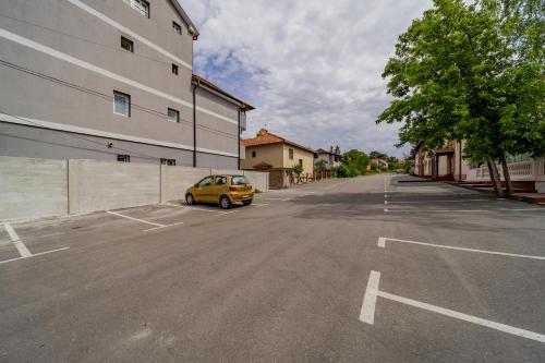 a car parked in a parking lot next to a building at Forty One Suites Belgrade Apartments in Voždovac