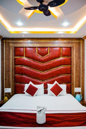 a bedroom with a large bed with a wooden headboard at HOTEL COUNTRY INN in Dimāpur