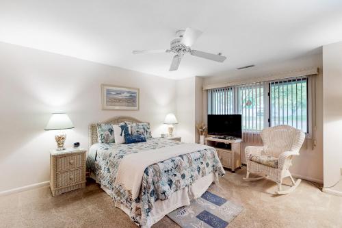 a bedroom with a bed and a flat screen tv at Spring Lake --- 20784 East Dr Unit 503 in Rehoboth Beach