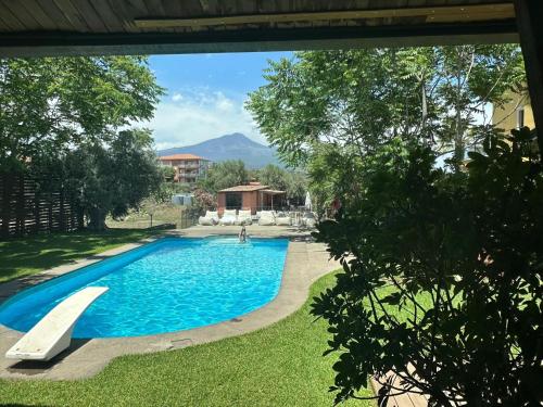 a view of a swimming pool in a yard at Ottomood B&B and Apartments in Tremestieri Etneo