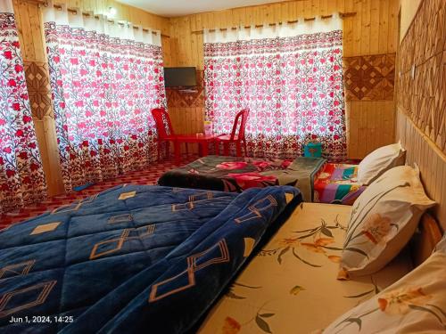 a room with two beds and two windows at Green Street in Pahalgām
