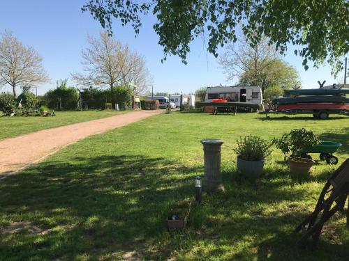a grassy field with a dirt road in a park at Glampingpod in Loitz