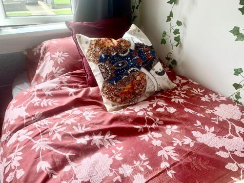 a bed with a teddy bear pillow on it at Large room in excellent location double or two singles in Dublin