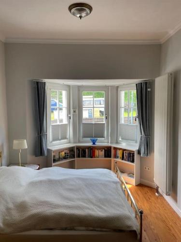 a bedroom with a large bed and two windows at Ferienwohnung Moselsteig in Reil