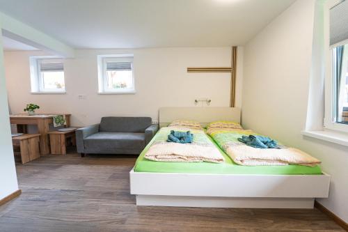 a bedroom with a bed and a chair at apartment Sun Di Bohinj in Bohinj
