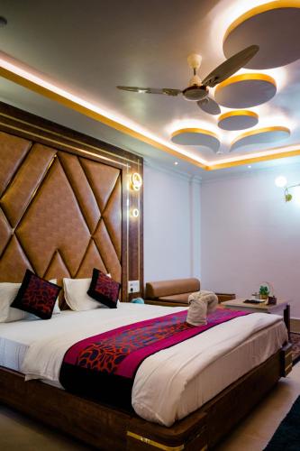 a bedroom with a large bed and a ceiling at HOTEL COUNTRY INN in Dimāpur