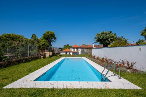 a swimming pool in the yard of a house at HM - Oporto Studio Pool Oasis in Porto