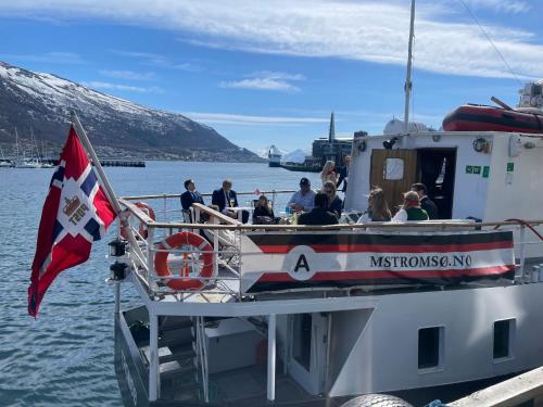 a group of people on a boat on the water at Norwegian Fjord Explorer Line in Tromsø