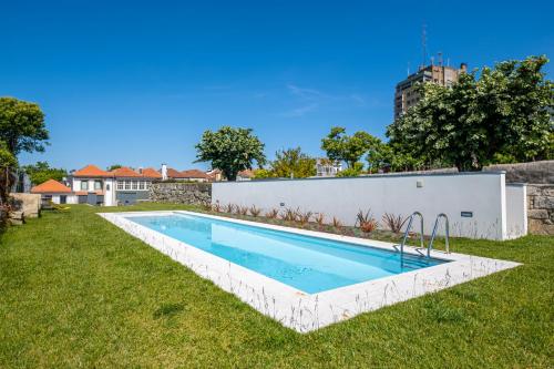 a swimming pool in the backyard of a house at HM - Oporto Studio Pool Oasis in Porto
