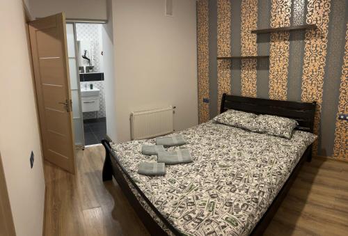 a bedroom with a bed with towels on it at VIP апартаменти ЦЕНТР in Rivne