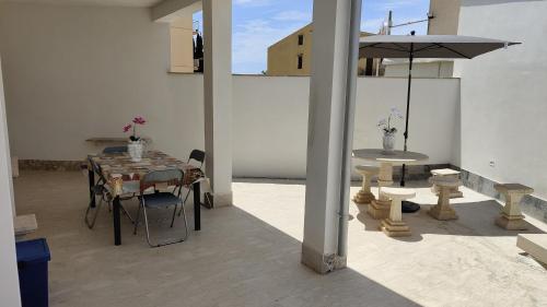 a dining room with a table and an umbrella at Sicilia bedda in Custonaci