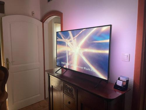 a flat screen tv sitting on top of a dresser at B&B Monroe in Averbode