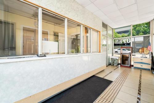 an empty room with large windows in a building at Capitol Inn and Suites in Montgomery