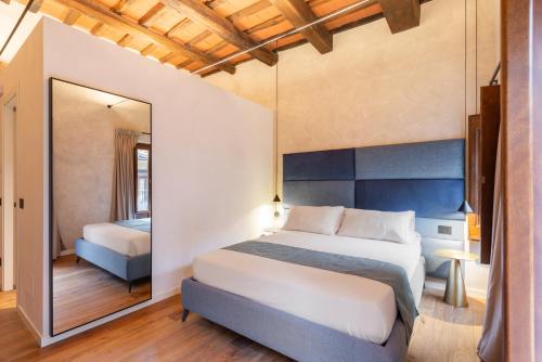 a bedroom with a large bed and a mirror at Residenza Leutari in Rome