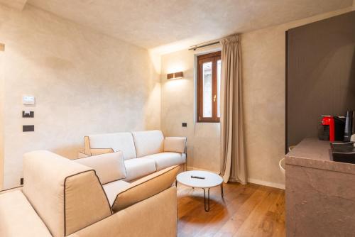 a living room with a white couch and a table at Residenza Leutari in Rome
