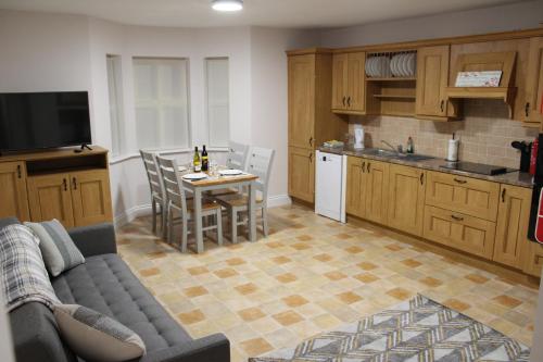 a kitchen with a couch and a table with chairs at Dunneill River Rest in Charlesfort
