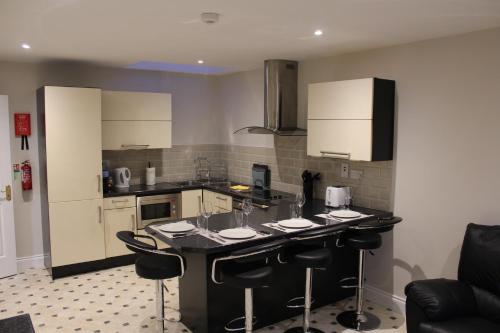 a kitchen with a island with bar stools at Dunneill River Rest in Charlesfort