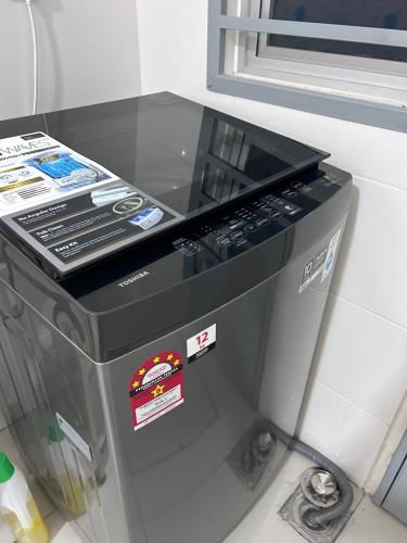 a large appliance is sitting on a table at Cool Gateaway Seremban Homestay in Labu
