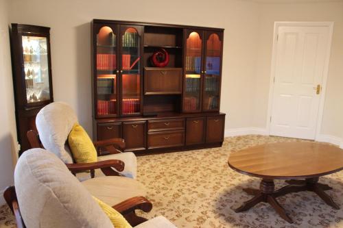 a living room with two chairs and a table at Dunneill River Rest in Charlesfort