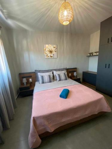 a bedroom with a large bed with a blue pillow on it at Stavros luxury apartment in Skiathos